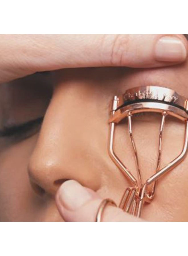 Professional eyelash curler with stainless steel body and spring handle, rose gold, 10cm long - Image 1
